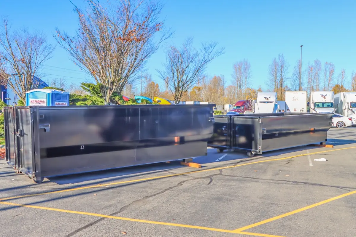 Professional dumpster rental service with roll-off container on residential driveway in Berthoud